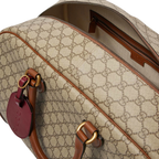 Gucci GG Canvas Medium Leather - Trimmed Duffel Bag in Beige - detail view 4 showing the bag's shape, material finish and visible design details.
