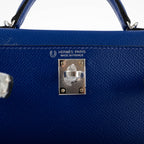 Blue handbag with Hermès Paris logo and 'Made in France' stamp on a white background