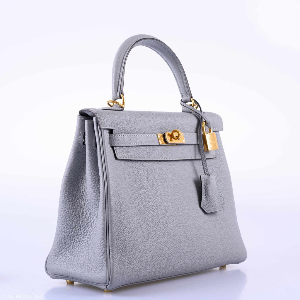 Gray handbag with gold hardware on a white background