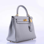 Gray handbag with gold hardware on a white background