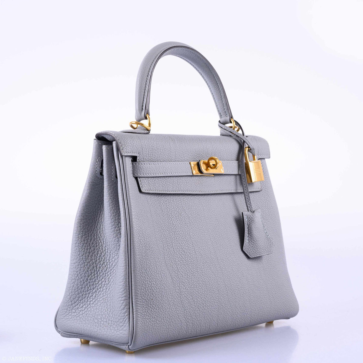 Gray handbag with gold hardware on a white background