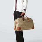 Gucci GG Canvas Medium Leather - Trimmed Duffel Bag in Beige - detail view 8 showing the bag's shape, material finish and visible design details.
