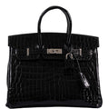 Front view of Birkin 25 in shiny black crocodile leather