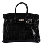 Front view of Birkin 25 in shiny black crocodile leather