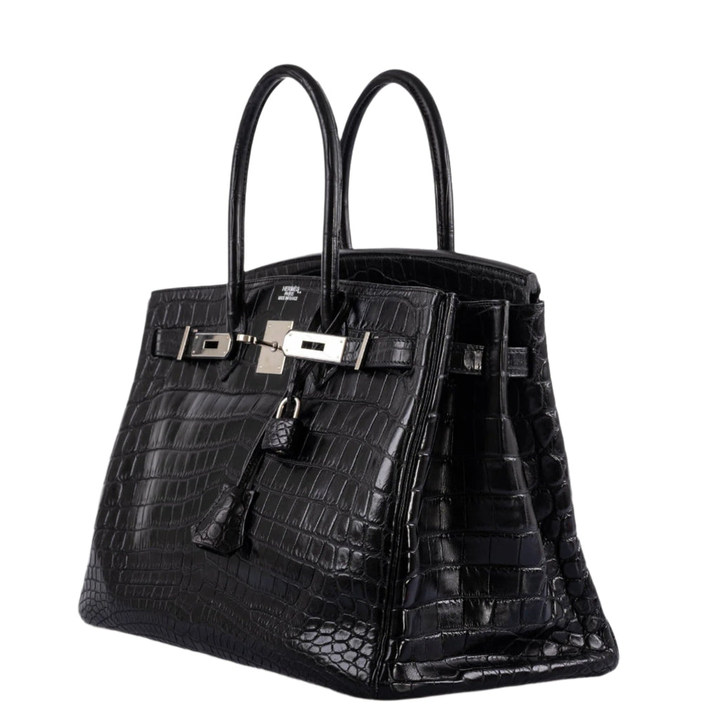 Detailed close-up of top handle stitching on black crocodile Birkin