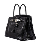 Detailed close-up of top handle stitching on black crocodile Birkin