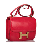 Side profile of Hermes Constance 24 in Rouge Exotique with gold hardware