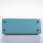 Top handle and flap closure of Kelly 25 in Blue Atoll Tadelakt