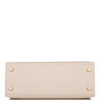 Close-up of front flap and toggle straps on Hermes Kelly 25 Craie with gold hardware