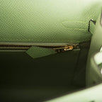Gold hardware toggle and sangles on Hermes Kelly 25 green bag