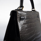 The bag with its accompanying clochette, lock, and keys