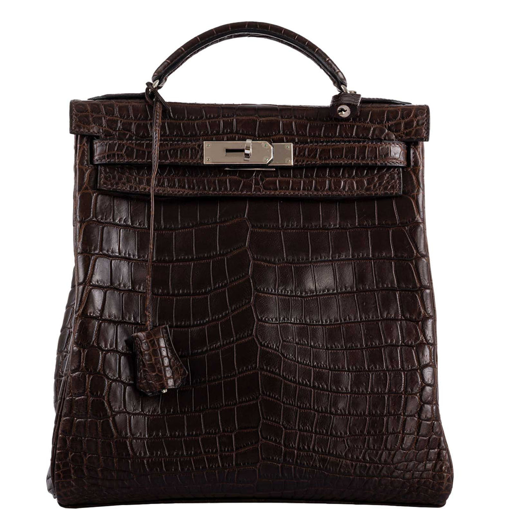 Vintage Hermes Kelly Ado 27 backpack in Matte Havane Nilo Crocodile with palladium hardware.