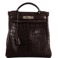 Vintage Hermes Kelly Ado 27 backpack in Matte Havane Nilo Crocodile with palladium hardware.