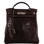 Vintage Hermes Kelly Ado 27 backpack in Matte Havane Nilo Crocodile with palladium hardware.