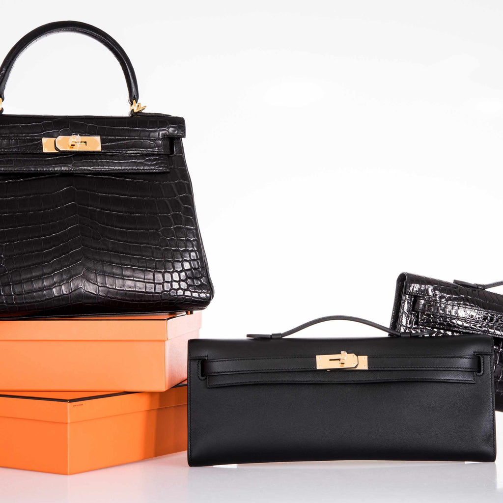 Angled display of Hermes Kelly Cut clutch in black Swift leather
