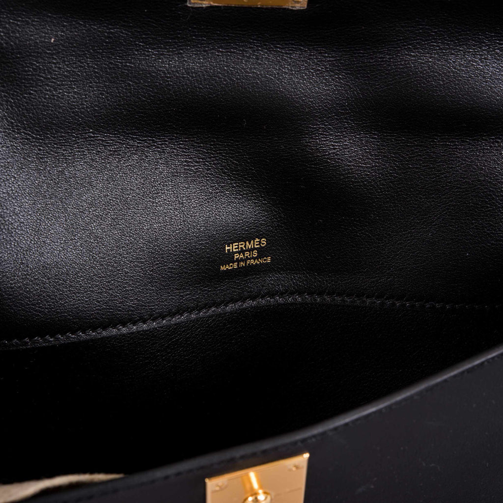 Detailed shot of stitching and gold clasp on Hermes Kelly Cut black Swift bag.