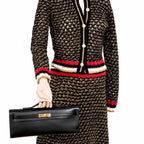 Side profile of Hermes Kelly Cut black Swift leather clutch.