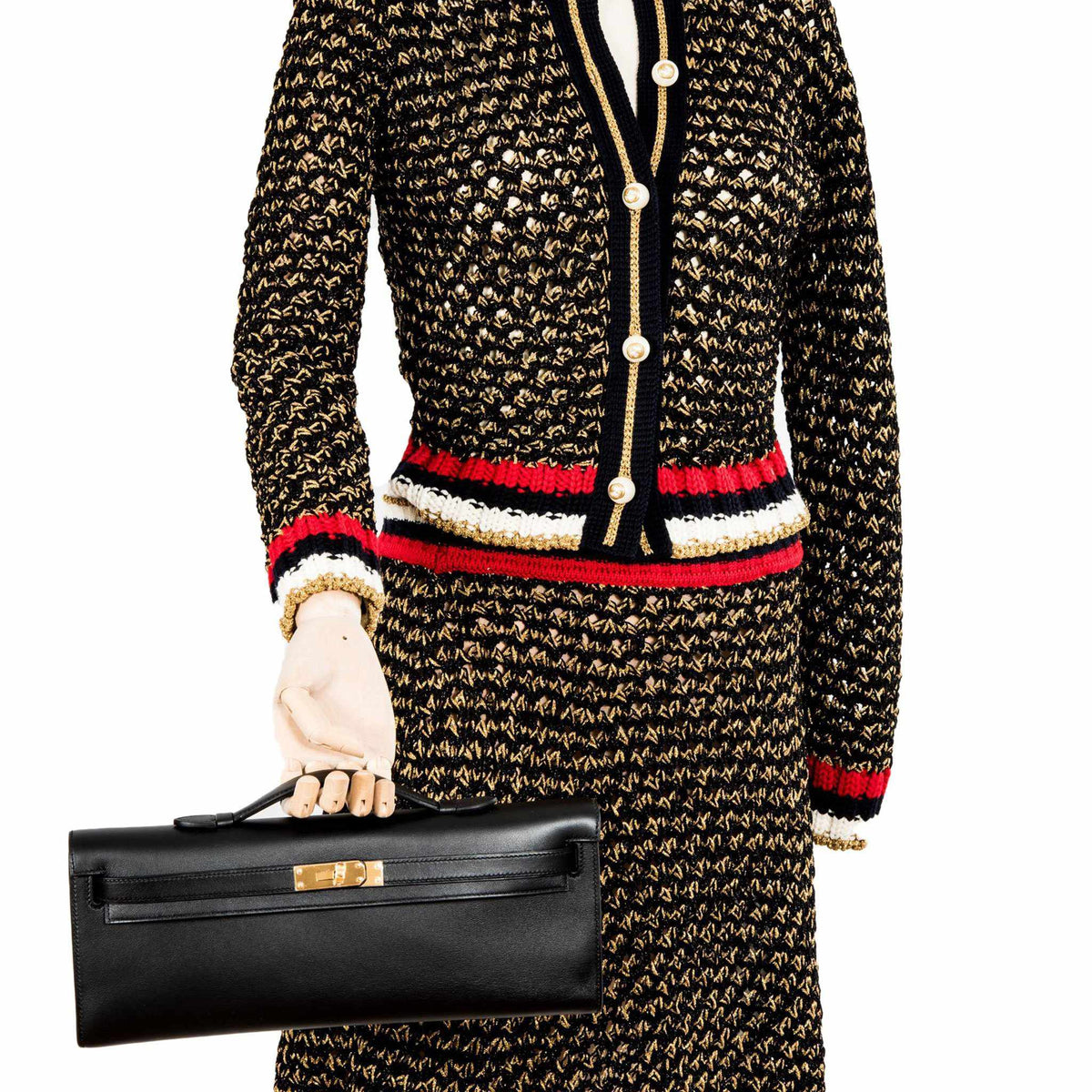 Side profile of Hermes Kelly Cut black Swift leather clutch.