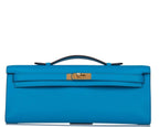 Hermes Kelly Cut clutch bag in Bleu Frida Swift leather with gold hardware.