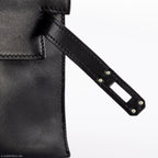 Luxury display of Hermes Kelly Mini Pochette in black Swift leather.