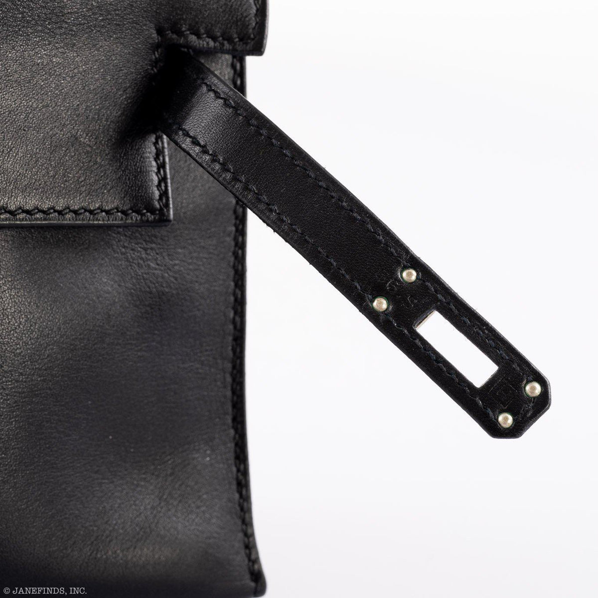 Luxury display of Hermes Kelly Mini Pochette in black Swift leather.