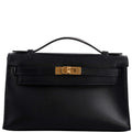 The clochette, lock, and keys in gold-tone hardware for the Hermes Kelly Mini Pochette