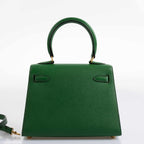 A shot of the clochette, lock, and keys in gold-tone hardware for the Kelly Mini Pochette