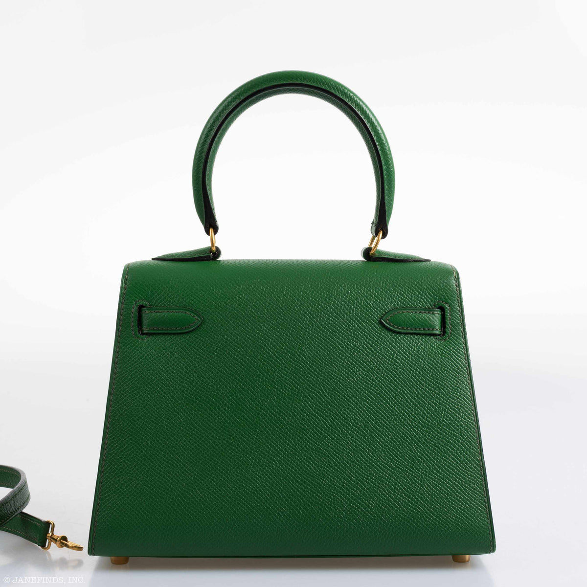 A shot of the clochette, lock, and keys in gold-tone hardware for the Kelly Mini Pochette