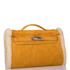 Side profile of Hermes shearling muff with palladium hardware