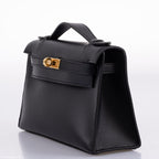 A top-down view of the Hermes Kelly Mini Pochette, showing the flap and handle