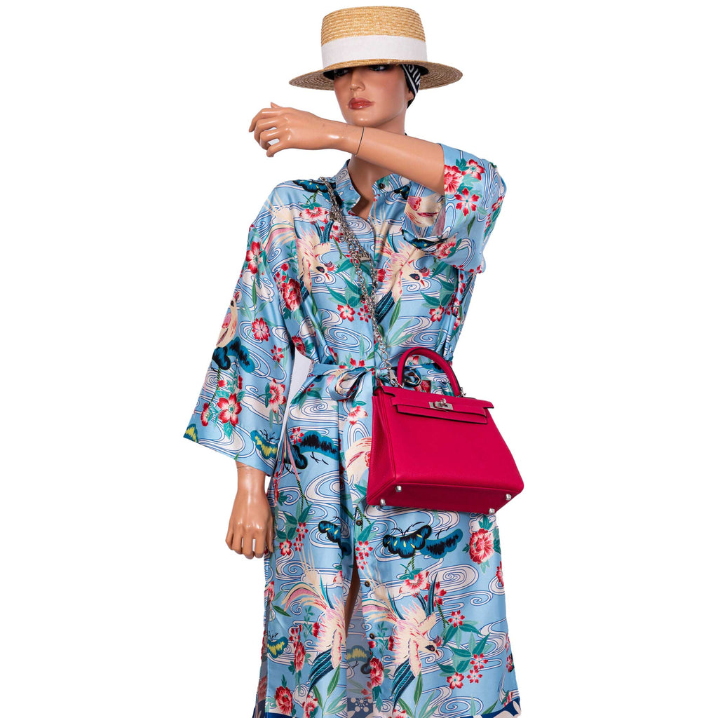 The Hermes Kelly Retourne 25 in Framboise Togo being carried on the forearm