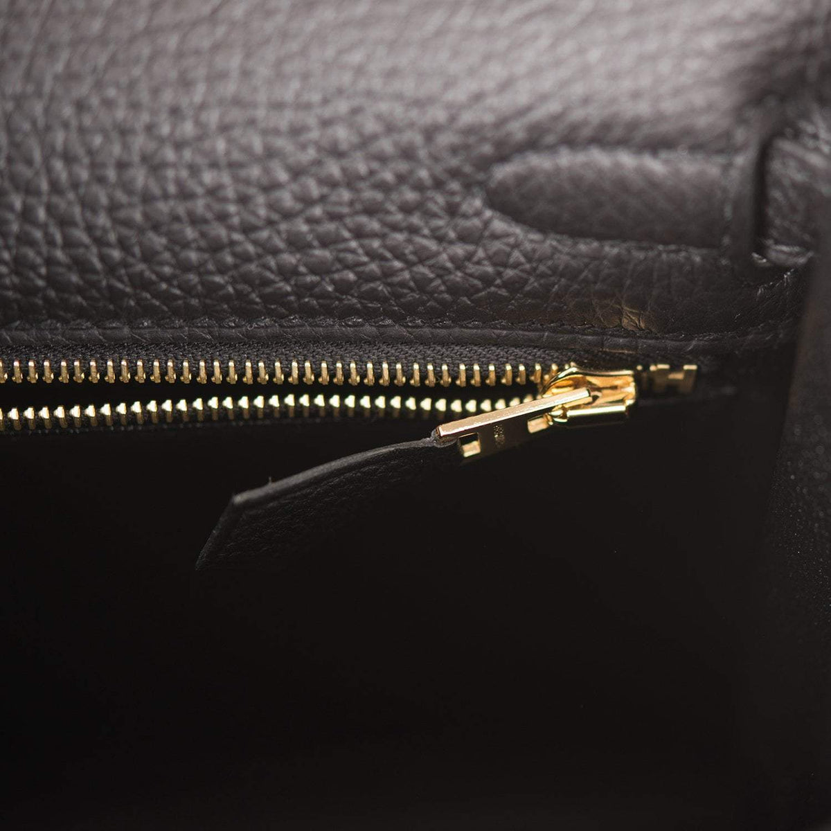 The clochette, lock, and keys in gold-tone hardware hanging from the handle