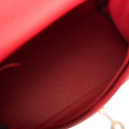 The interior of the bag with the flap open, showing the open pockets