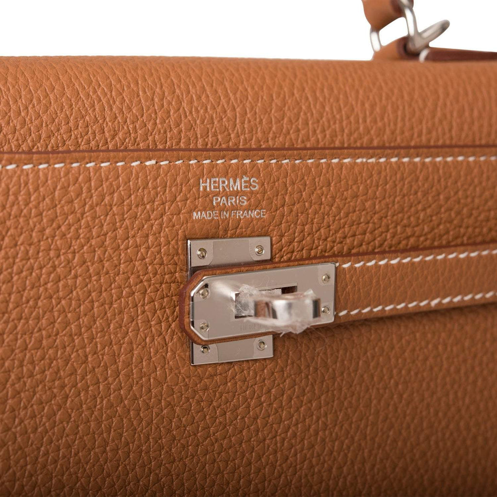 The palladium-tone clochette, lock, and keys hanging from the handle