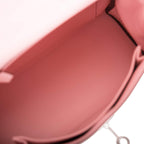 The Hermes Kelly Retourne 25 in Rose Sakura worn over the shoulder