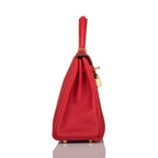 The Hermes Kelly Retourne 25 in Rouge Casaque Togo leather displayed on a surface