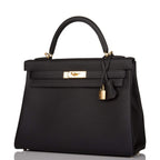 The clochette, lock, and keys in gold-tone hardware hanging from the handle