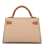 A close-up of the gold-tone toggle closure on the front flap of the bag