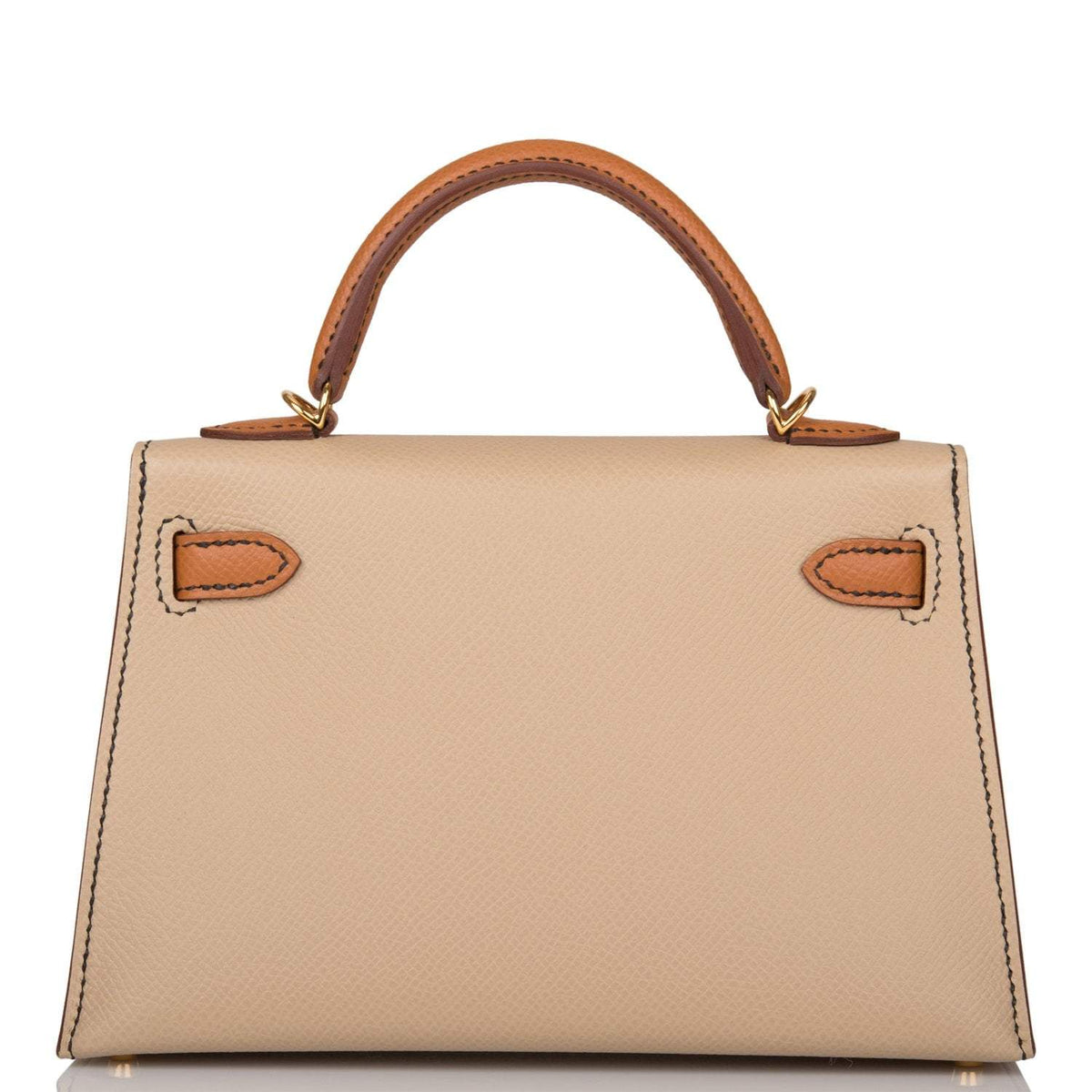 A close-up of the gold-tone toggle closure on the front flap of the bag