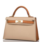 The handbag being carried on the forearm, highlighting its elegant size