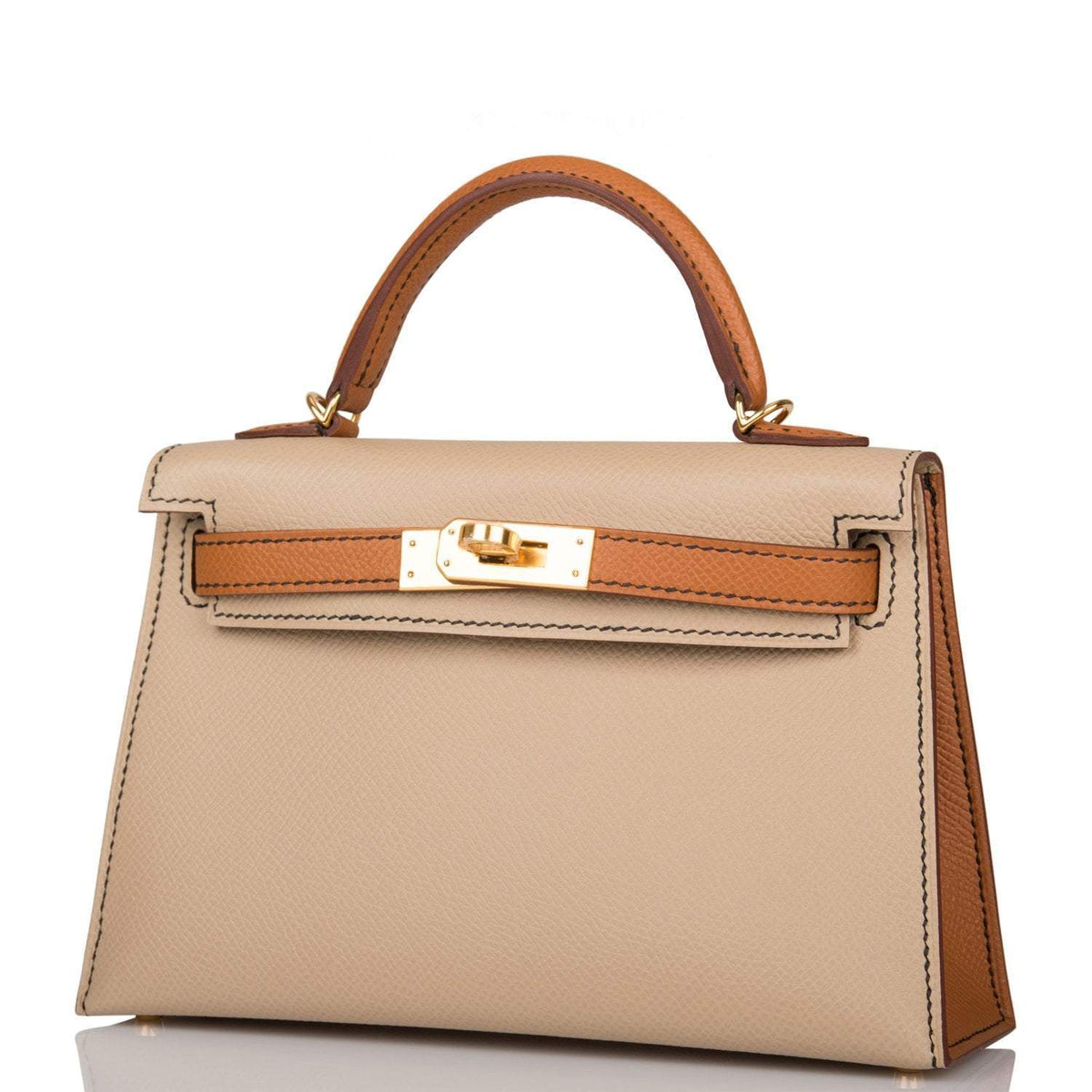 The handbag being carried on the forearm, highlighting its elegant size