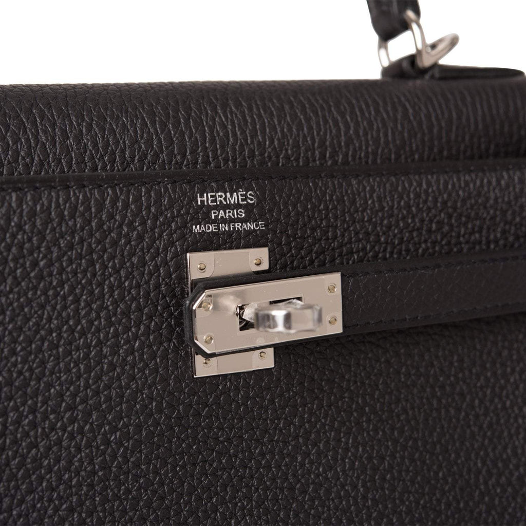 A close-up of the palladium-tone hardware, clochette, and lock.