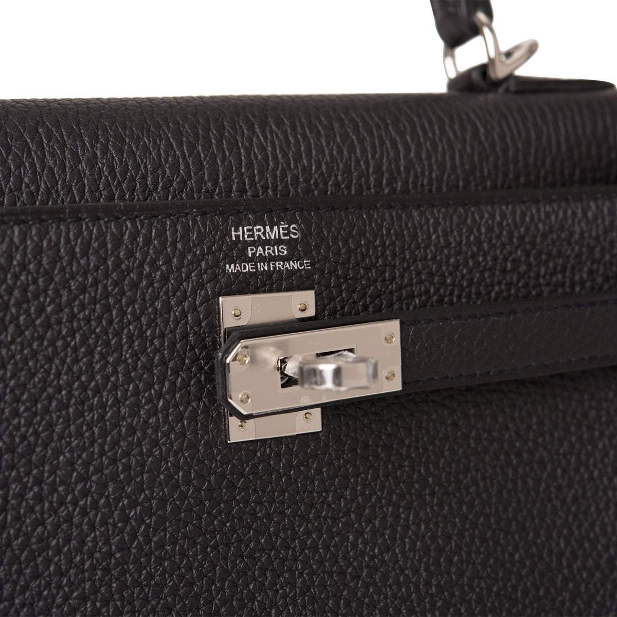 A close-up of the palladium-tone hardware, clochette, and lock.