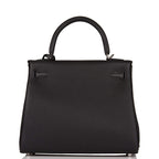 A view of the signature palladium-tone turn-lock on the front flap of the bag