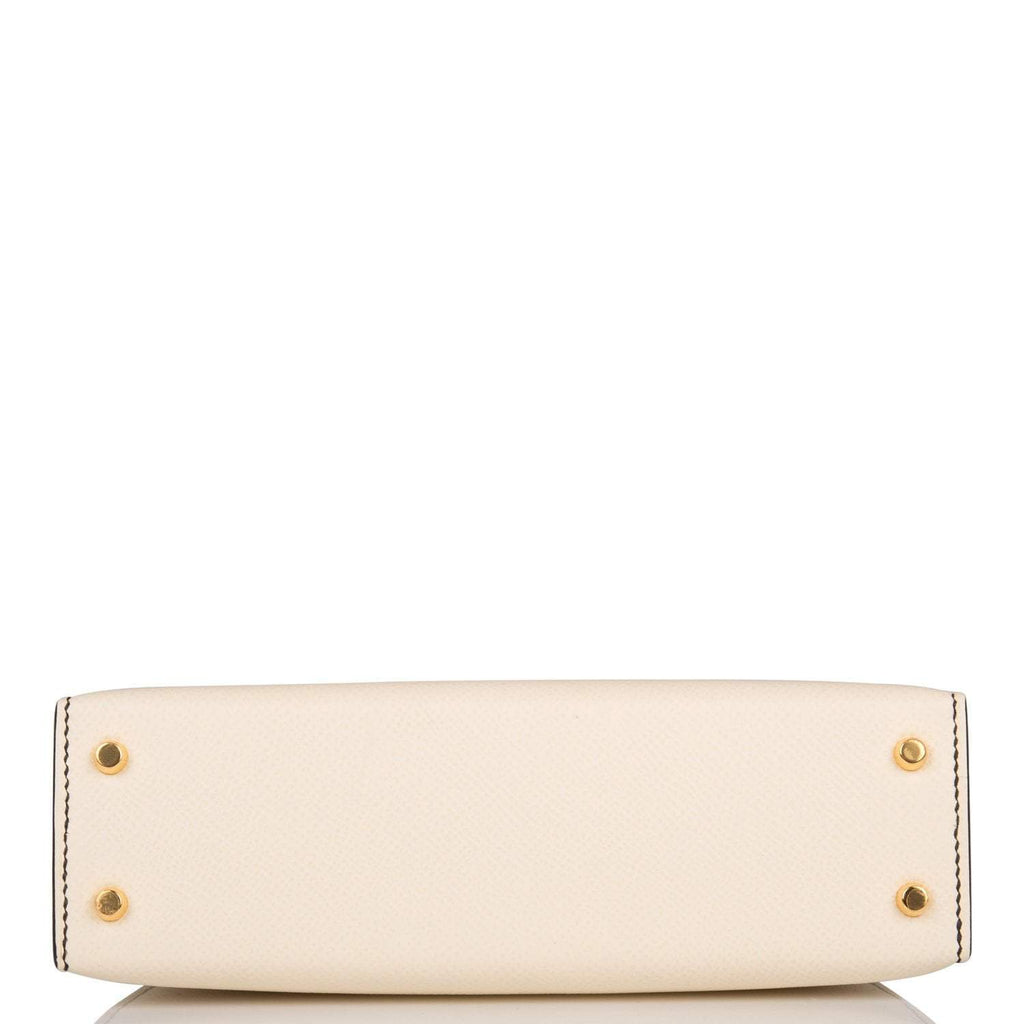 A close-up of the removable shoulder strap and its gold-tone hardware