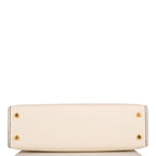 A close-up of the removable shoulder strap and its gold-tone hardware