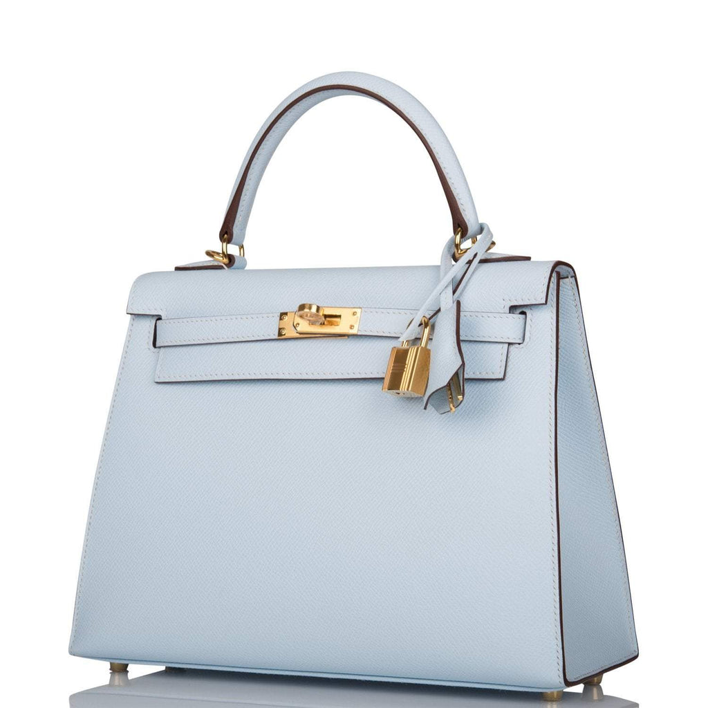 The clochette, lock, and keys in gold-tone hardware hanging from the handle
