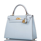 The clochette, lock, and keys in gold-tone hardware hanging from the handle