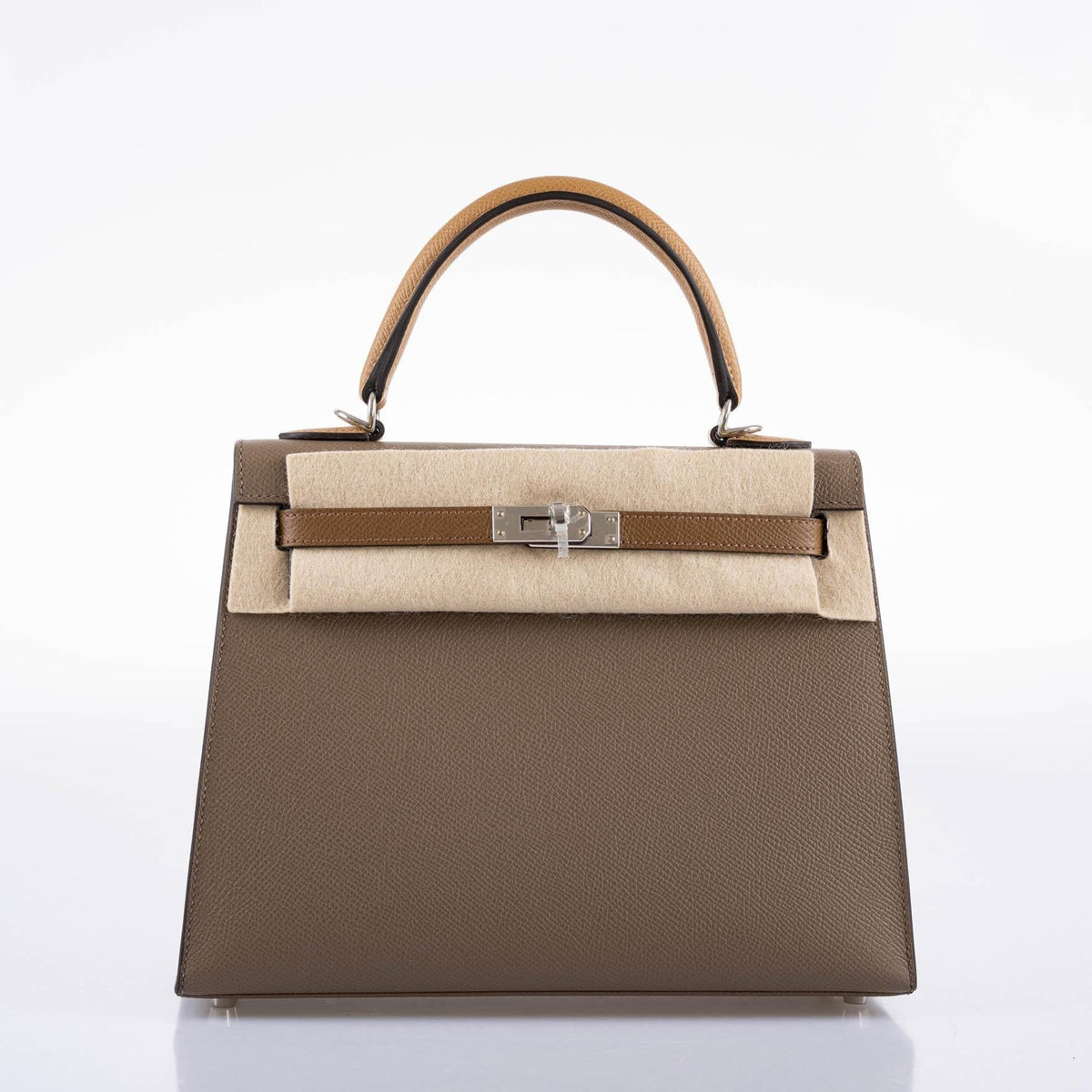 A detailed shot of the rolled top handle and the hanging clochette