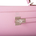 The bag being carried on the crook of an arm, showcasing its elegant proportion
